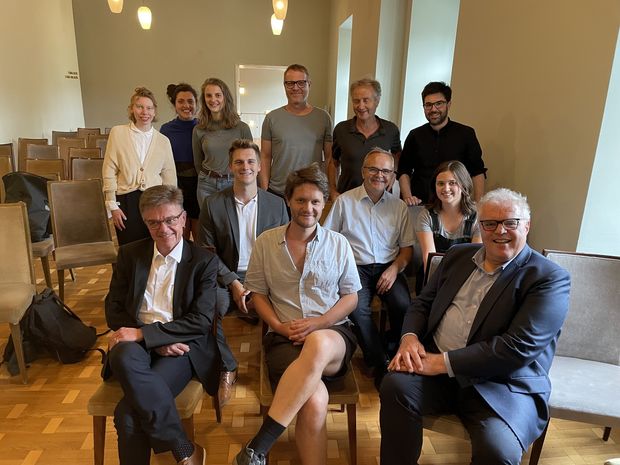 From the left: Front: Birklbauer, Julian Sigl (actor playing "K" in the production), Matthias Neumayr (OGH); Second row seated: Brezina, Resch, Anja Jemc (assistant director); standing back from right: dramaturge Martin Mader, director Peter Wittenberg.  and other cast members.