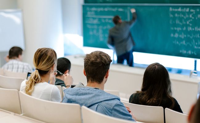 Vortragender und Studierende im Hörsaal