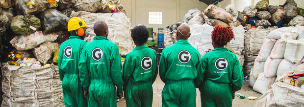 Müllsammler aus Kenia stehen vor Plastikmüll